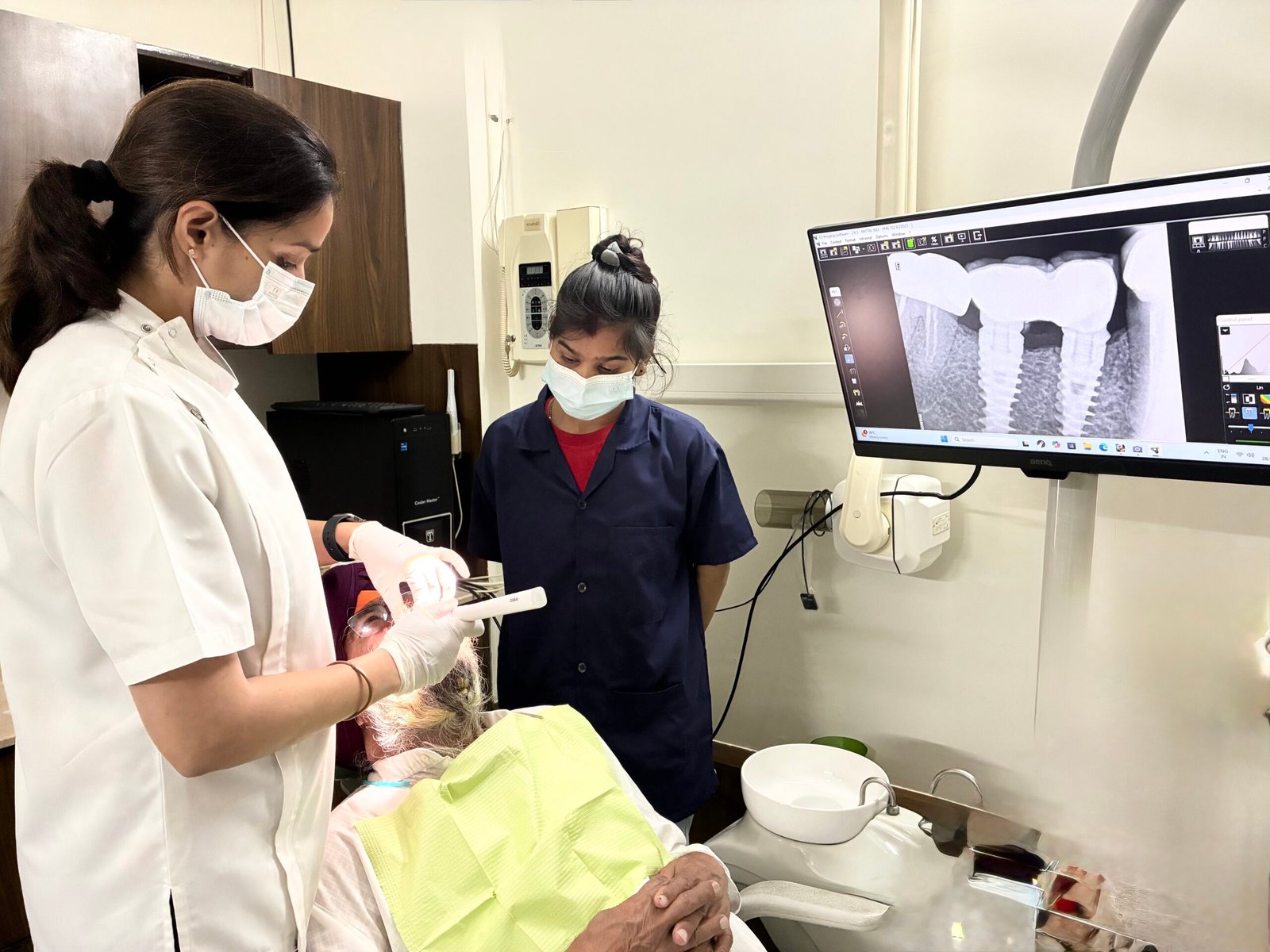 Dr Arjita Sood doing dental implant procedure on patient in dental clinic
