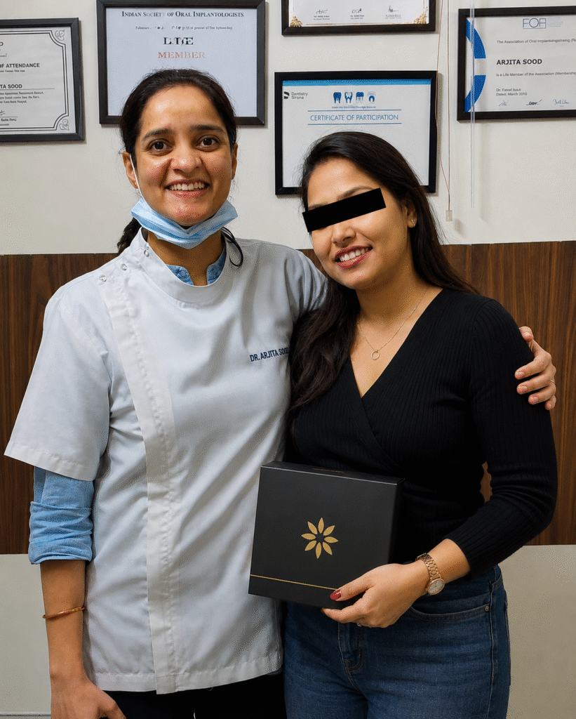 Dr. Arjita Sood with a patient after clear aligner treatment at Svaastha Dental Clinic in Sector 23 Gurgaon.
