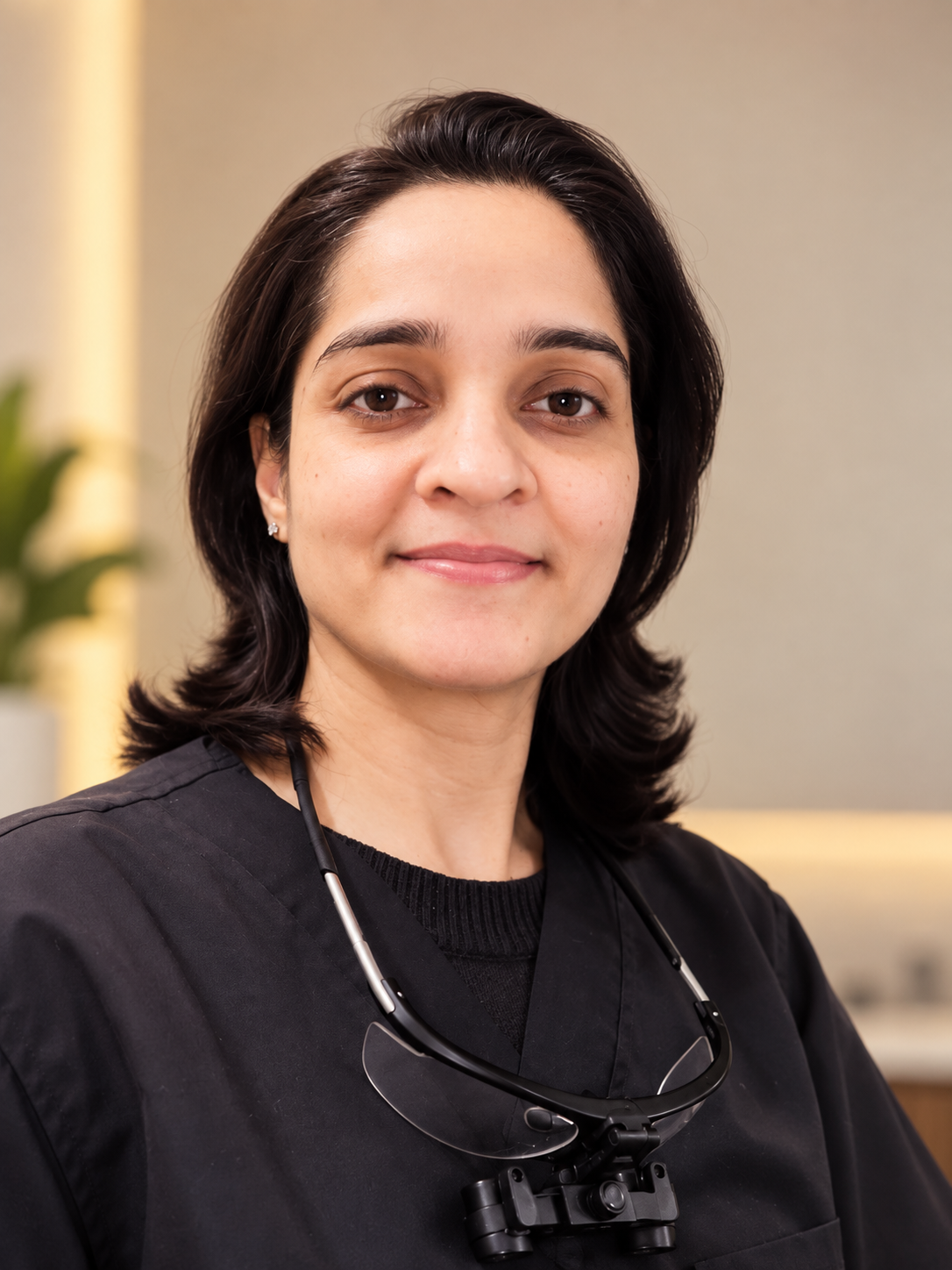 Dr. Arjita Sood, dentist in gurgaon smiling confidently in her dental clinic